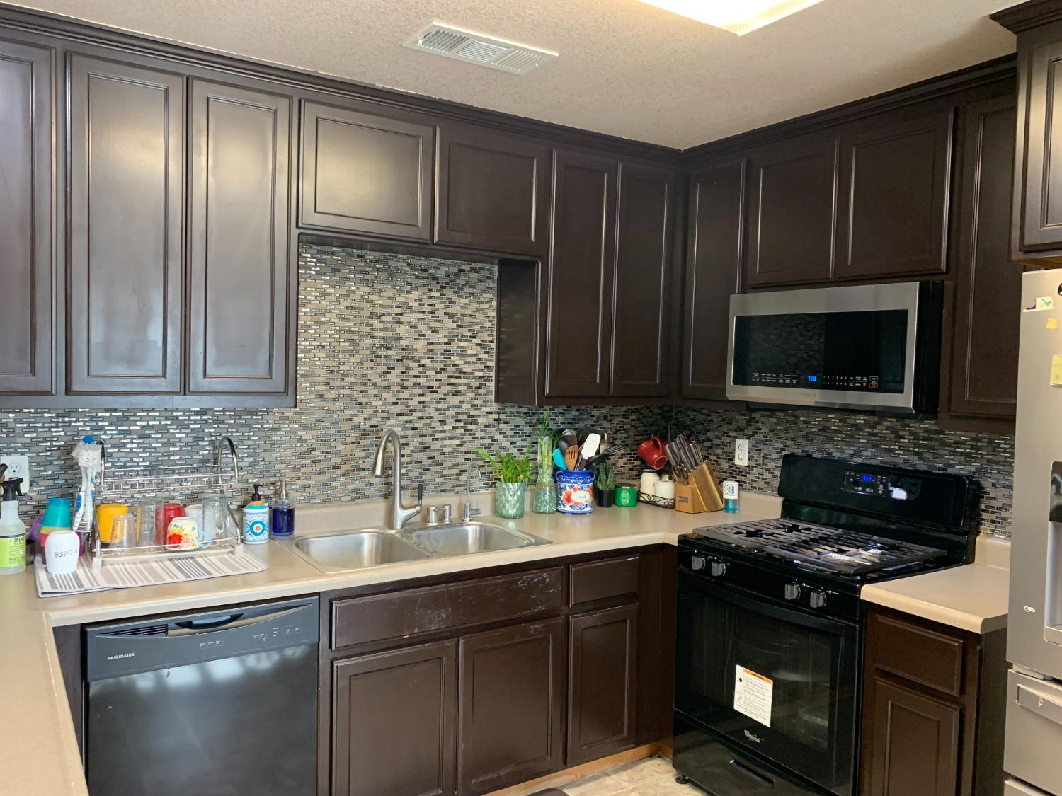 348 Silva Street Mendota, CA 93640 - Photo 5 of 24 a kitchen with a sink stove and microwave