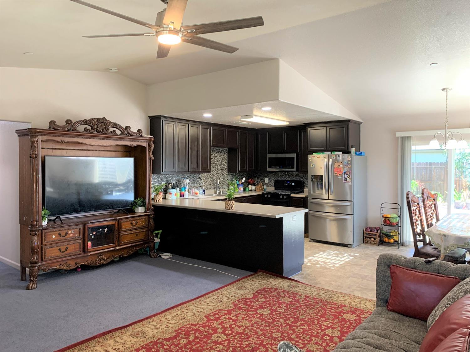 348 Silva Street Mendota, CA 93640 - Photo 9 of 24 a living room with furniture and a flat screen tv