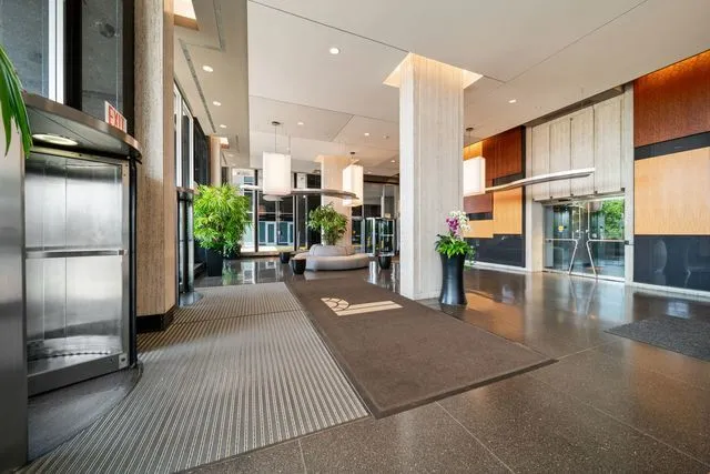 a lobby with furniture and a potted plant