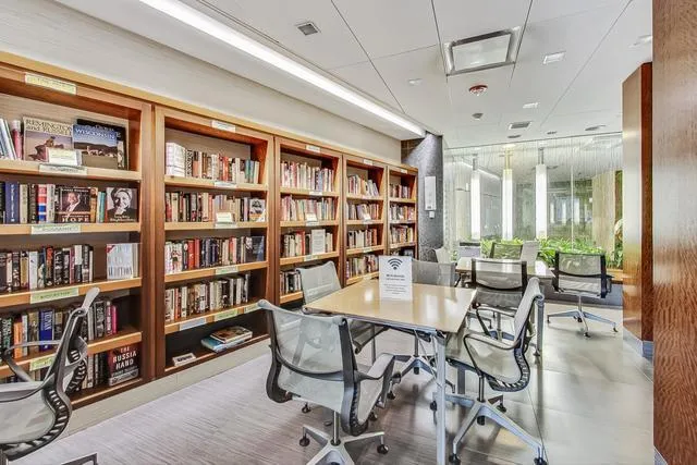 a view of a livingroom and a dining room with furniture window and wooden floor