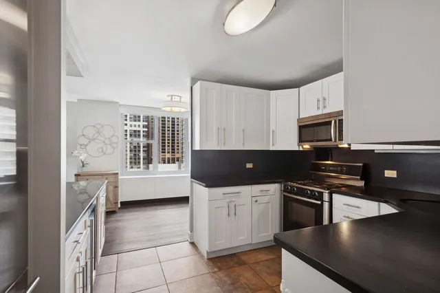 a kitchen with stainless steel appliances a stove sink and cabinets