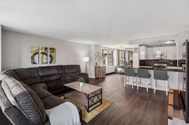 a living room with furniture and kitchen view