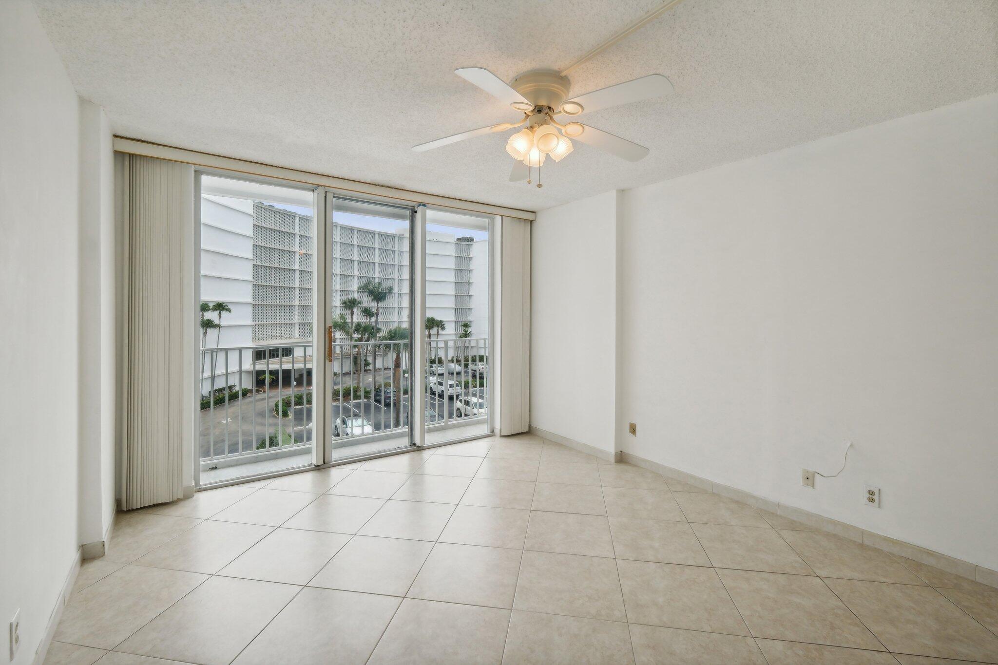 3580 South Ocean Boulevard, Unit 4C South Palm Beach, FL 33480 - Photo 14 of 36 a view of an empty room with glass door