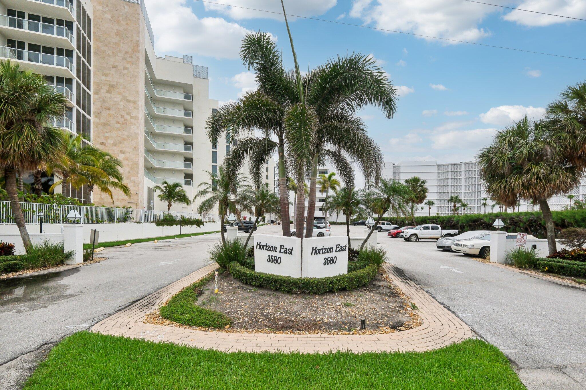 3580 South Ocean Boulevard, Unit 4C South Palm Beach, FL 33480 - Photo 18 of 36 a view of a backyard with a fountain plants and palm trees