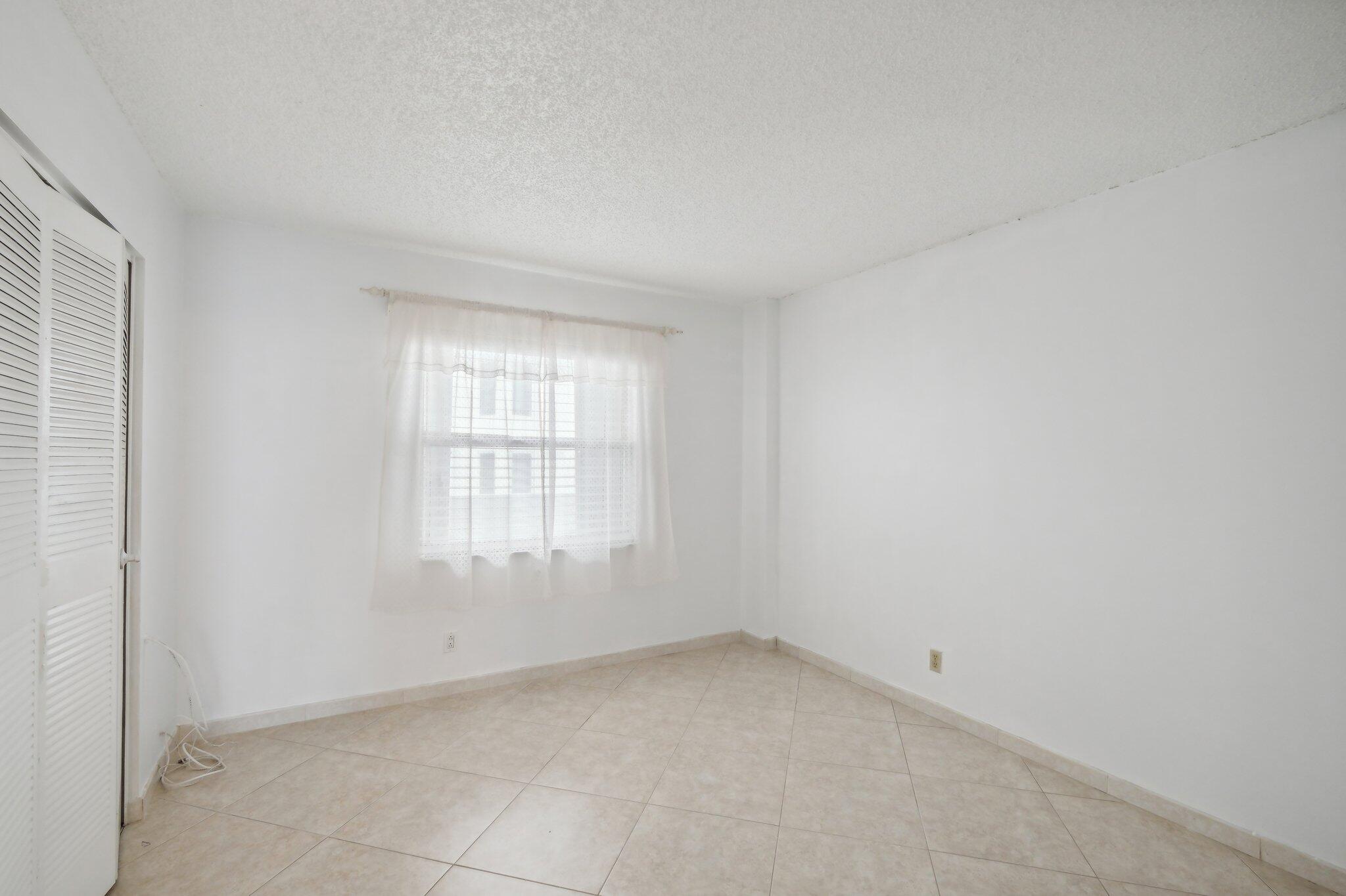 3580 South Ocean Boulevard, Unit 4C South Palm Beach, FL 33480 - Photo 19 of 36 an empty room with a window
