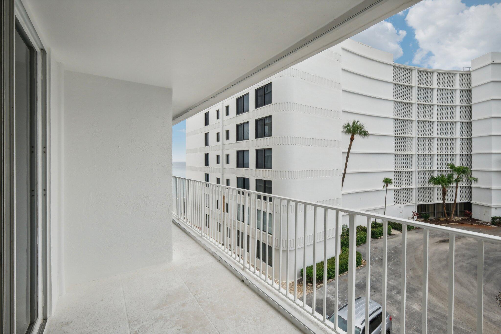 3580 South Ocean Boulevard, Unit 4C South Palm Beach, FL 33480 - Photo 22 of 36 a view of staircase with white walls and a window