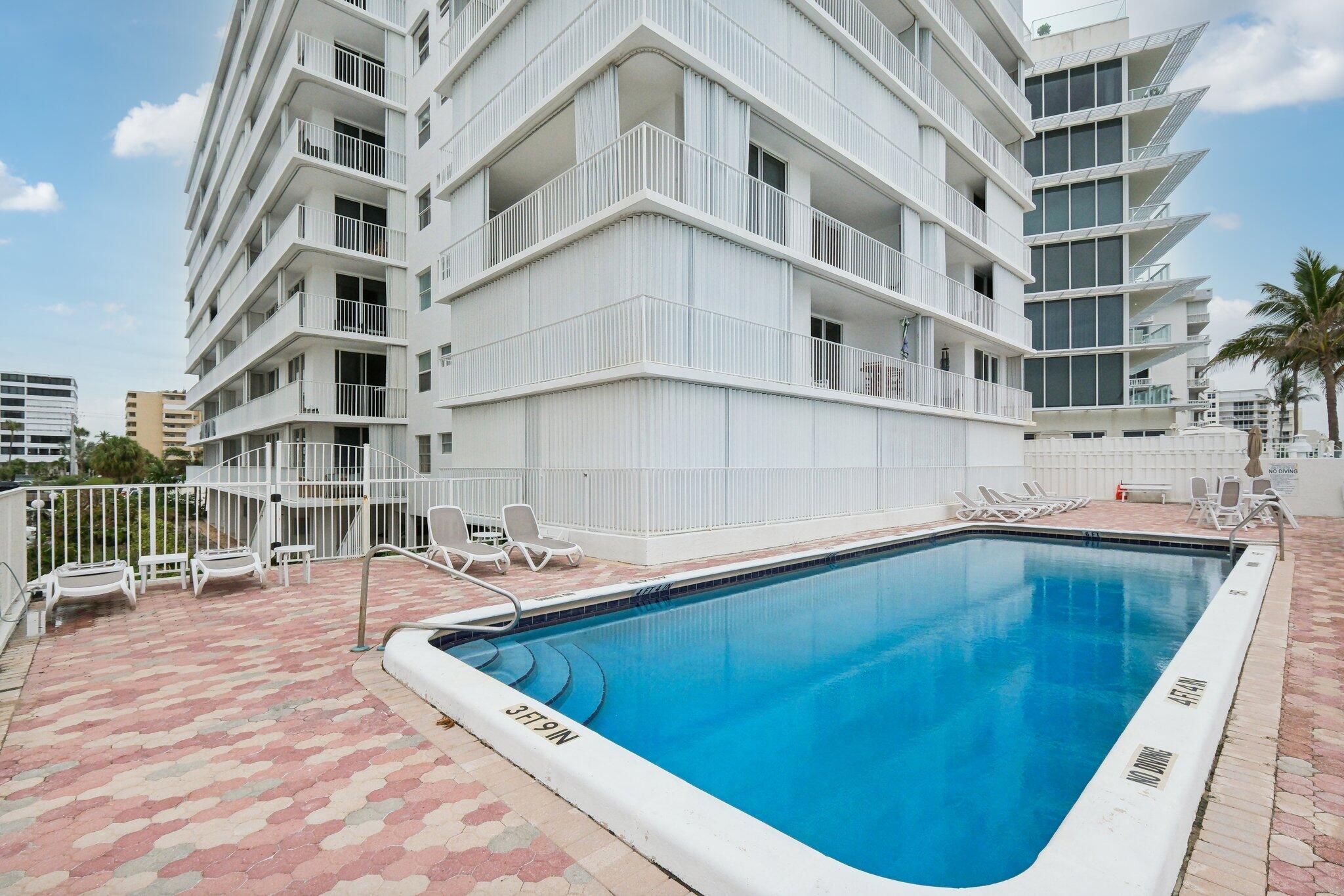 3580 South Ocean Boulevard, Unit 4C South Palm Beach, FL 33480 - Photo 26 of 36 a view of buildings with swimming pool