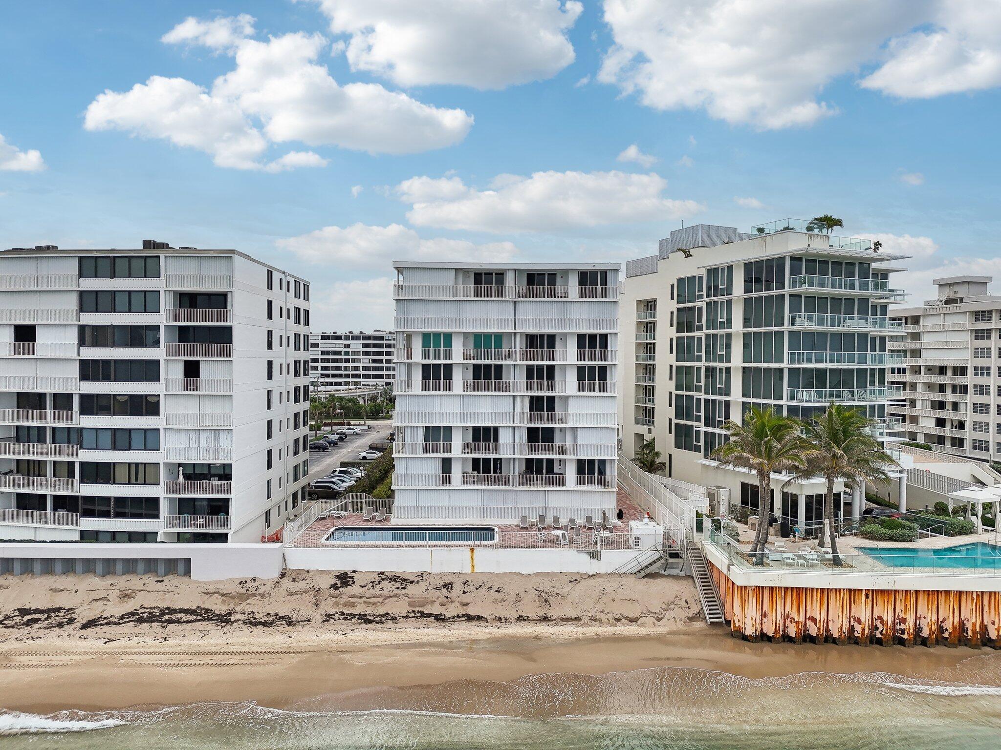 3580 South Ocean Boulevard, Unit 4C South Palm Beach, FL 33480 - Photo 27 of 36 a front view of a building with glass windows and door
