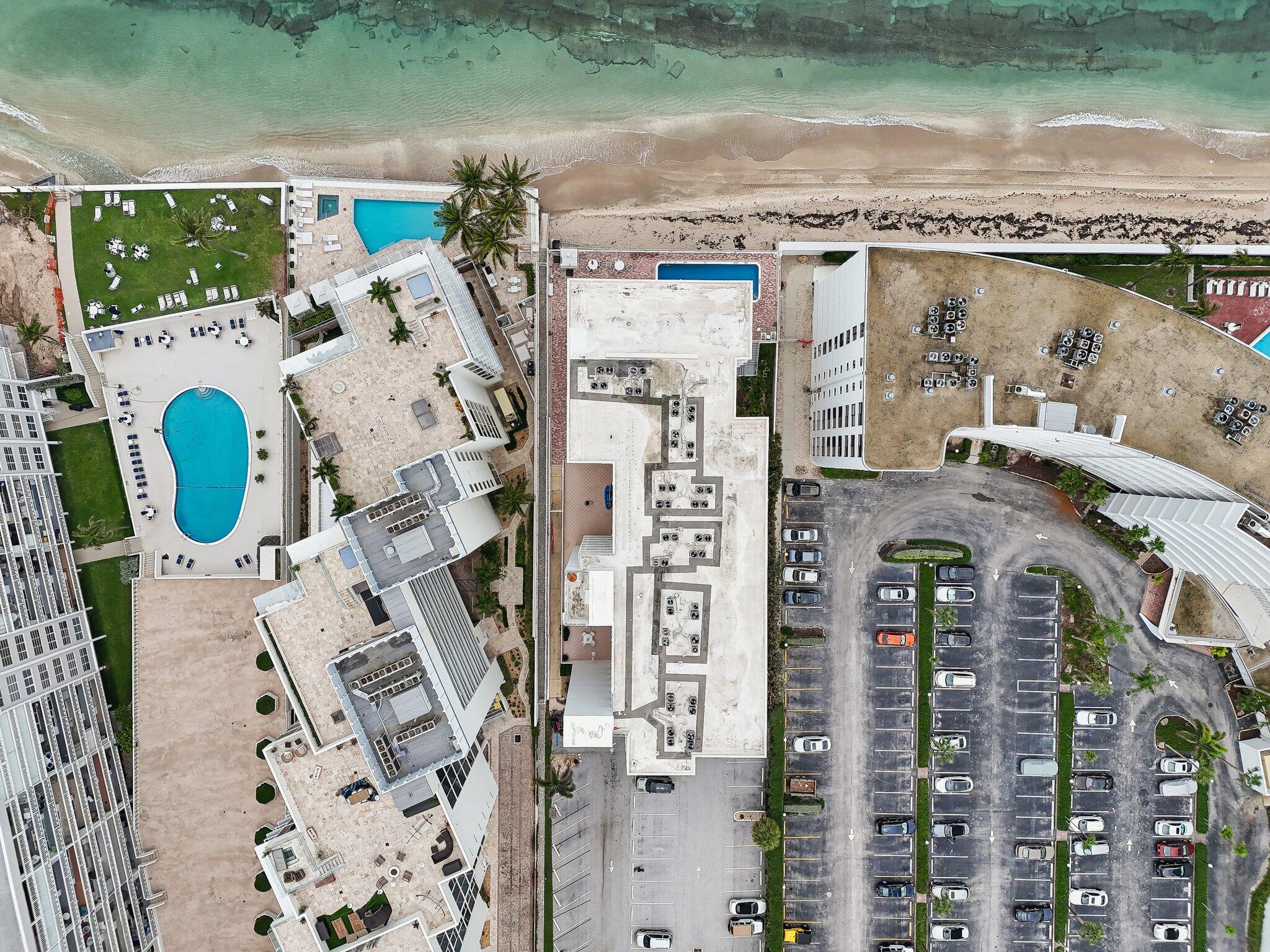 3580 South Ocean Boulevard, Unit 4C South Palm Beach, FL 33480 - Photo 32 of 36 an aerial view of residential houses with outdoor space and parking