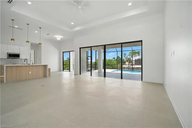 a view of an empty room with a kitchen
