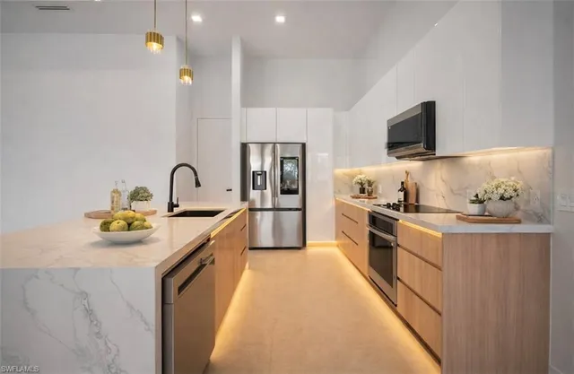 a kitchen with a sink stove and refrigerator
