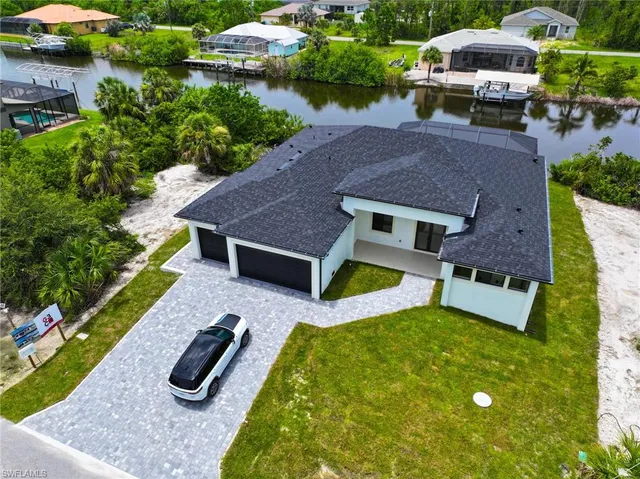 an aerial view of a house with swimming pool garden and patio