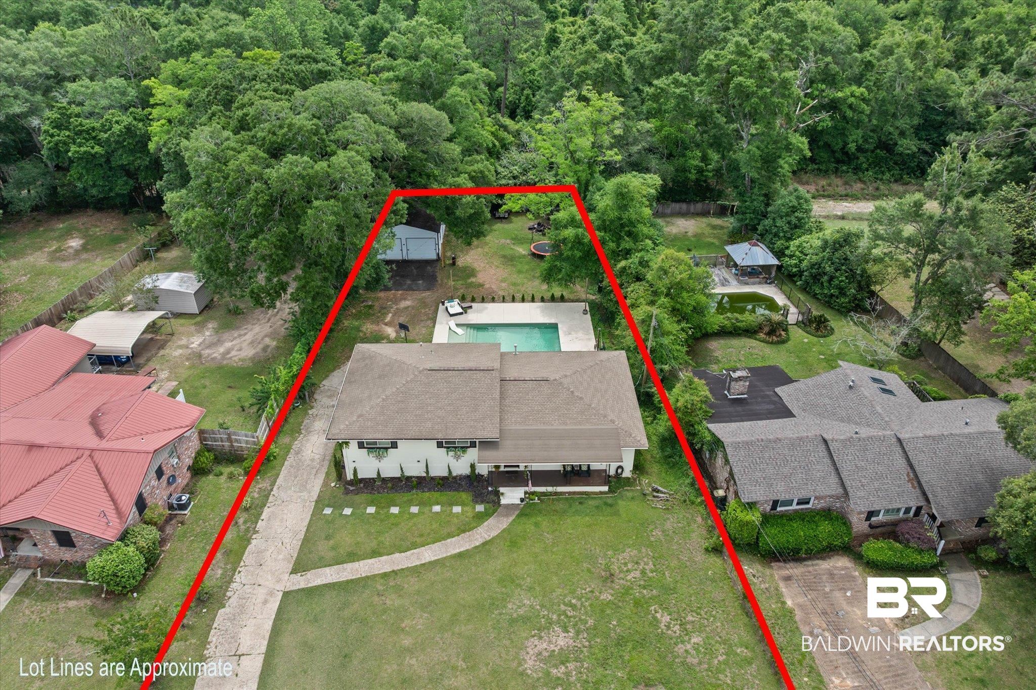 4213 Shan Drive East Mobile, AL 36693 - Photo 31 of 35 Expansive lot featuring a main residence with a rectangular swimming pool, mature trees, a long driveway, and a detached outbuilding