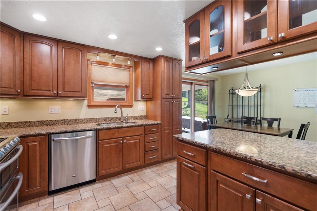 2027 Cutter Drive McKees Rocks, PA 15136 - Photo 3 of 22 a kitchen with granite countertop stainless steel appliances a sink stove and cabinets
