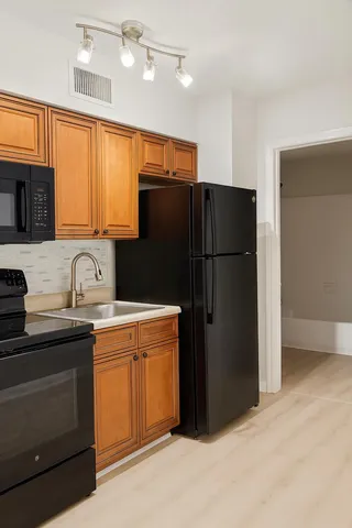a kitchen with a refrigerator and a sink