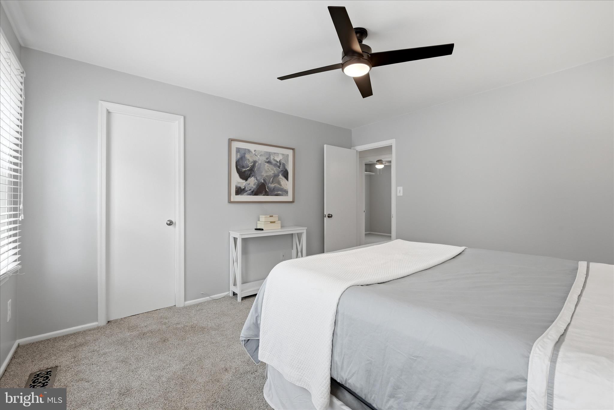 5446 Lighthouse Lane Burke, VA 22015 - Photo 14 of 36 a bedroom with a bed and a painting on the wall