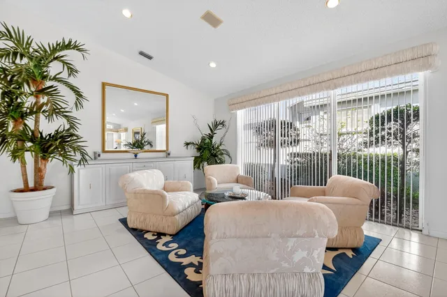 a living room with furniture potted plant and a window