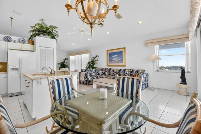 a kitchen with stainless steel appliances granite countertop a sink and a white cabinets