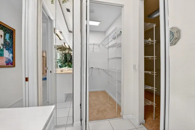 a bedroom with a bed and a view of kitchen