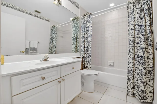 an aerial view of a city with lots of residential buildings ocean and mountain view in back