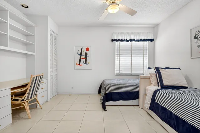 an aerial view of a house with a garden and lake view