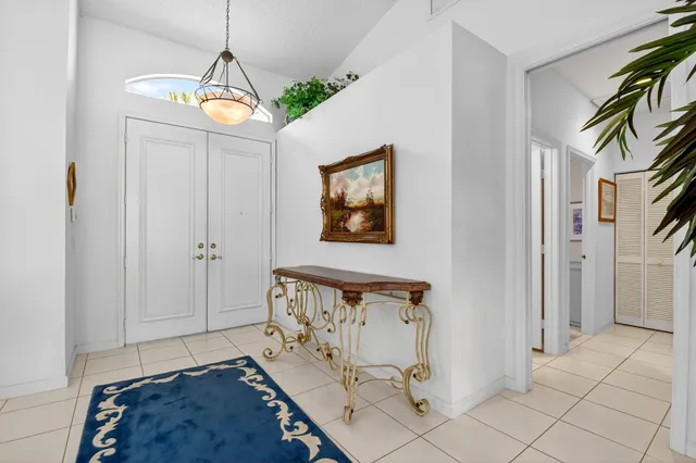 a living room with furniture a chandelier and a rug