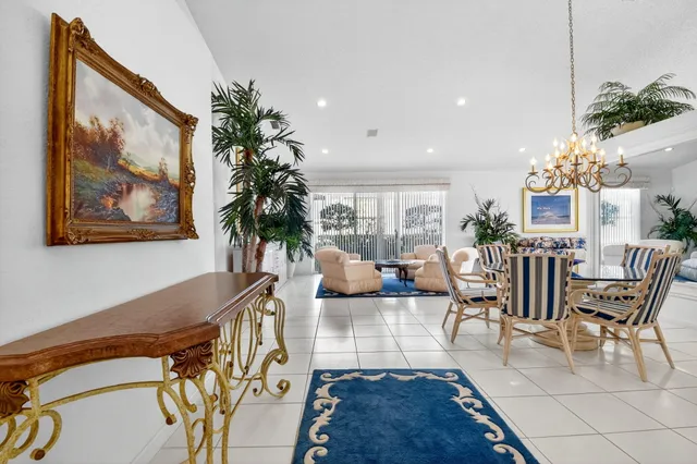 a view of a dining room with furniture and a chandelier