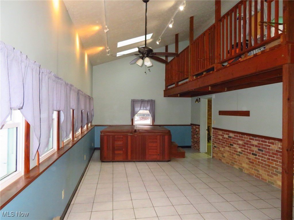 38505 Sugar Ridge Road North Ridgeville, OH 44039 - Photo 38 of 44 The Sun Porch features newer windows, ceramic tile flooring, celing fan, a vaulted ceiling w/ 2 skylights and a hot tub (needs a new dedicated electrical outlet to function again)