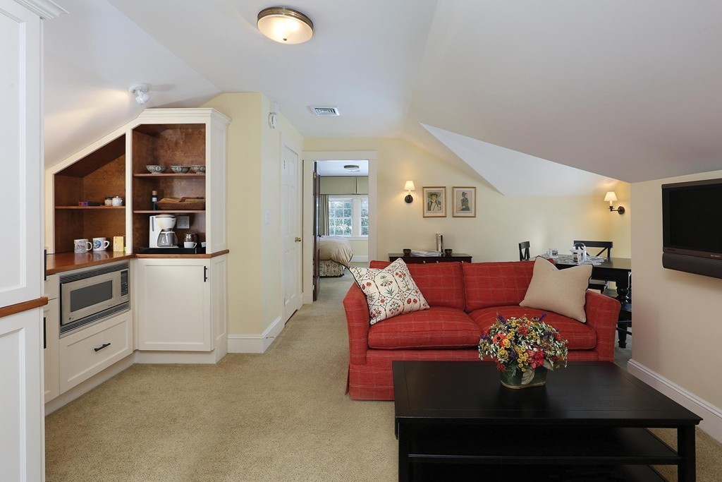 55 Devon Road Brookline, MA 02467 - Photo 11 of 12 a living room with furniture and a chandelier