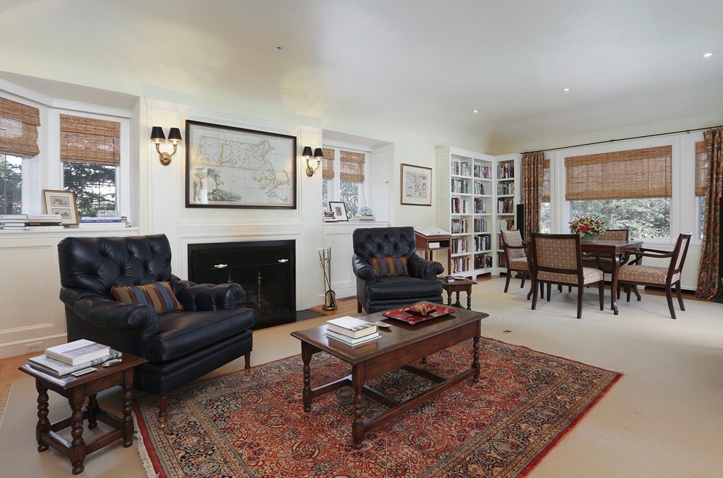 55 Devon Road Brookline, MA 02467 - Photo 4 of 12 a living room with furniture a table and a fireplace