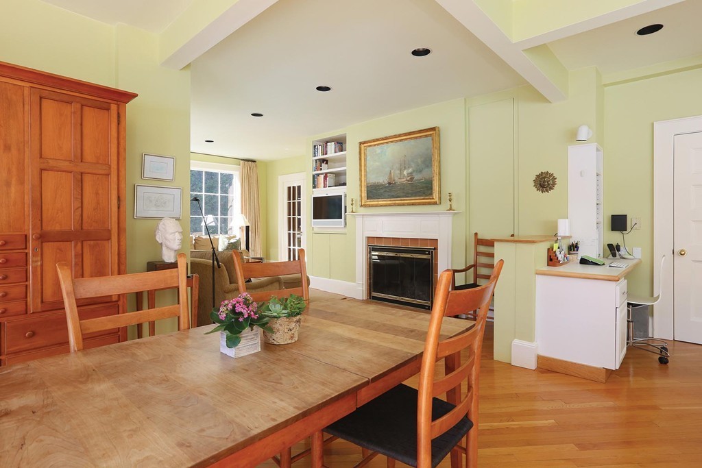 55 Devon Road Brookline, MA 02467 - Photo 8 of 12 a living room with furniture a fireplace and a table