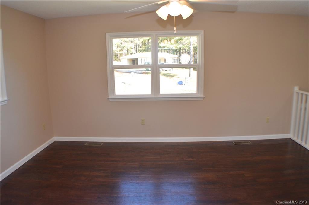 266 Cardinal Road Spindale, NC 28139 - Photo 6 of 15 an empty room with wooden floor and windows