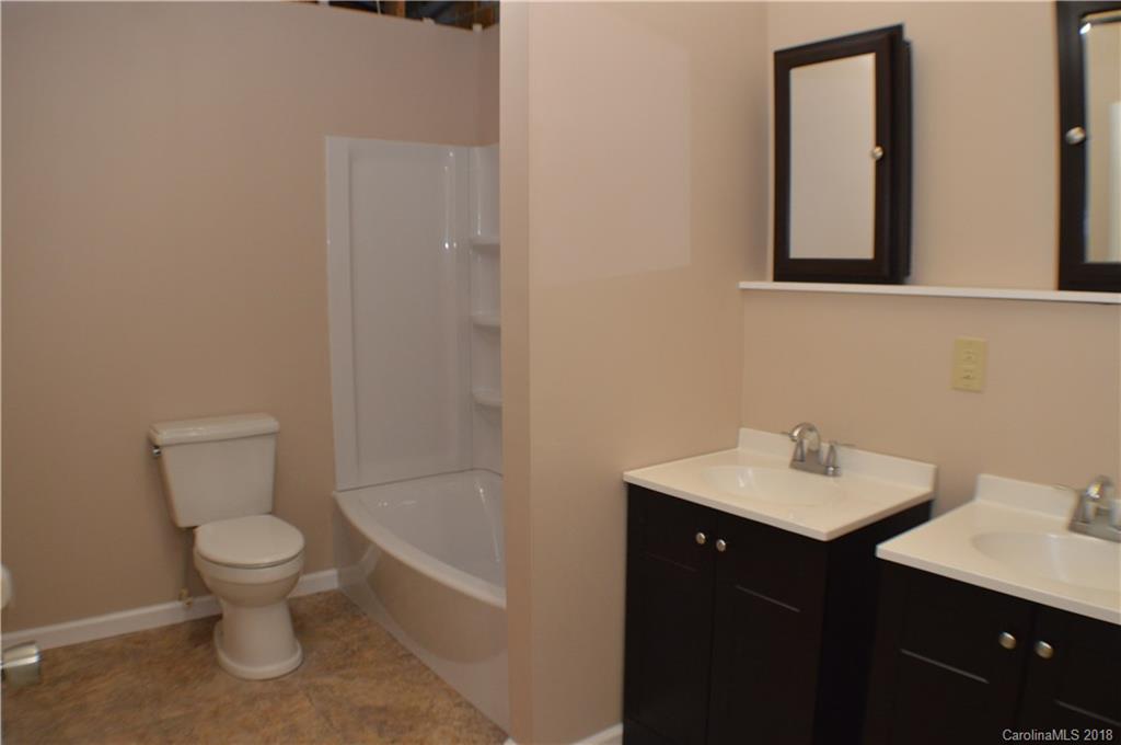 266 Cardinal Road Spindale, NC 28139 - Photo 9 of 15 a bathroom with a toilet a sink and mirror