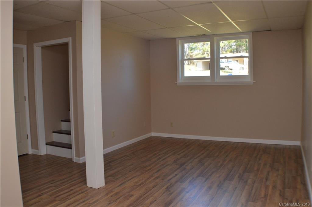 266 Cardinal Road Spindale, NC 28139 - Photo 10 of 15 an empty room with wooden floor and windows