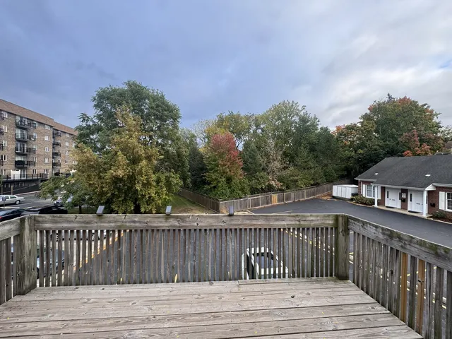 a view of a porch with wooden floor in front of city view