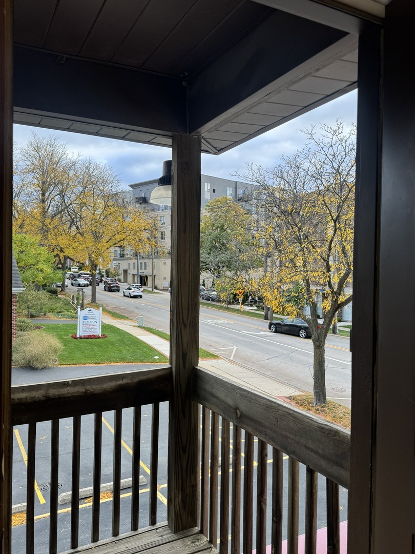 5145 Washington Street, Unit 2 Downers Grove, IL 60515 - Photo 16 of 16 a view of a porch with wooden floor in front of city view