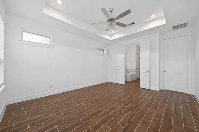 a view of an empty room with wooden floor