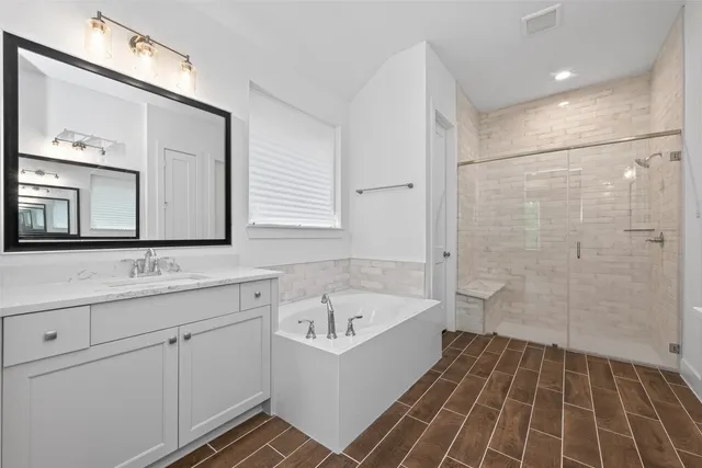a bathroom with a bathtub and a sink