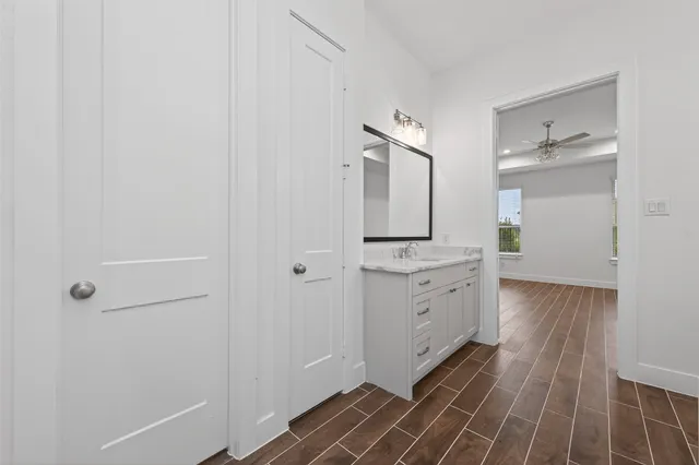 a spacious bathroom with a granite countertop sink and a mirror