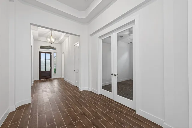a view of a hallway with wooden floor and closet