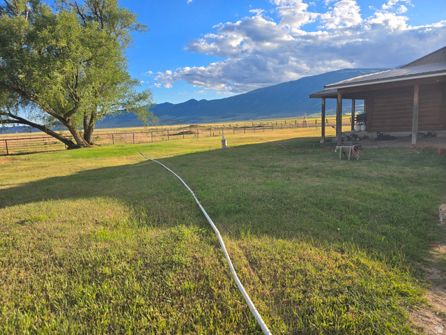 34200 Coulam Road Swan Lake, ID 83281 - Photo 3 of 24 Expansive green lawn with mountain backdrop