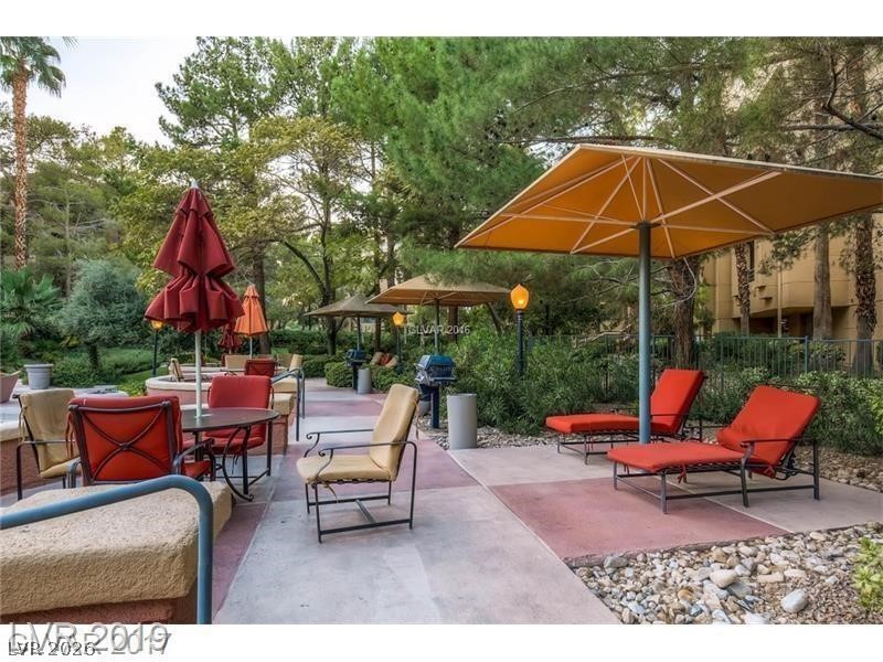 270 East Flamingo Road, Unit 227 Las Vegas, NV 89169 - Photo 10 of 12 Enjoy outdoor living with dedicated lounging and dining spaces under the shade of mature trees.