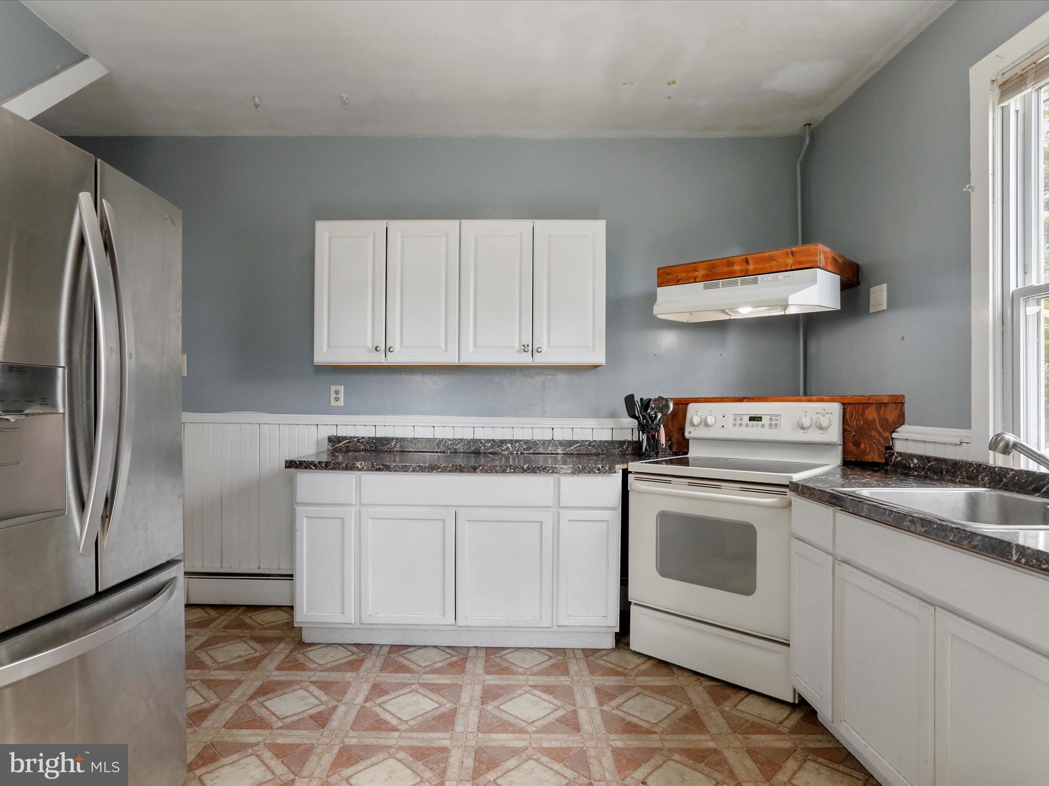 35 Middle Street Taneytown, MD 21787 - Photo 19 of 41 a kitchen with stainless steel appliances granite countertop a stove a sink and a refrigerator