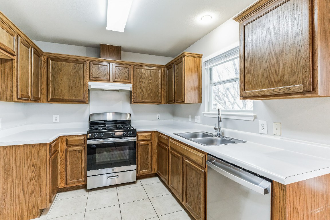 313 Caladium Drive Georgetown, TX 78626 - Photo 13 of 36 a kitchen with stainless steel appliances granite countertop a sink stove and cabinets
