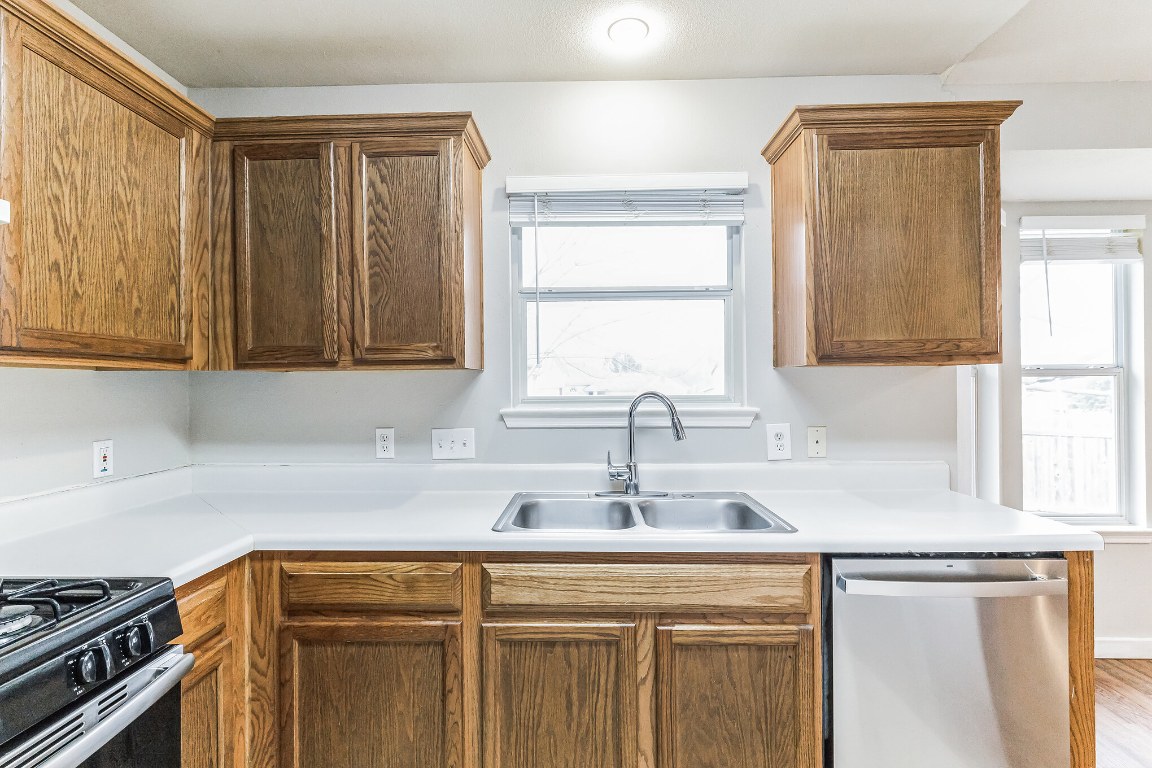 313 Caladium Drive Georgetown, TX 78626 - Photo 15 of 36 a kitchen with stainless steel appliances granite countertop a sink a stove and a window