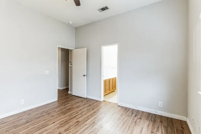 a view of empty room with wooden floor