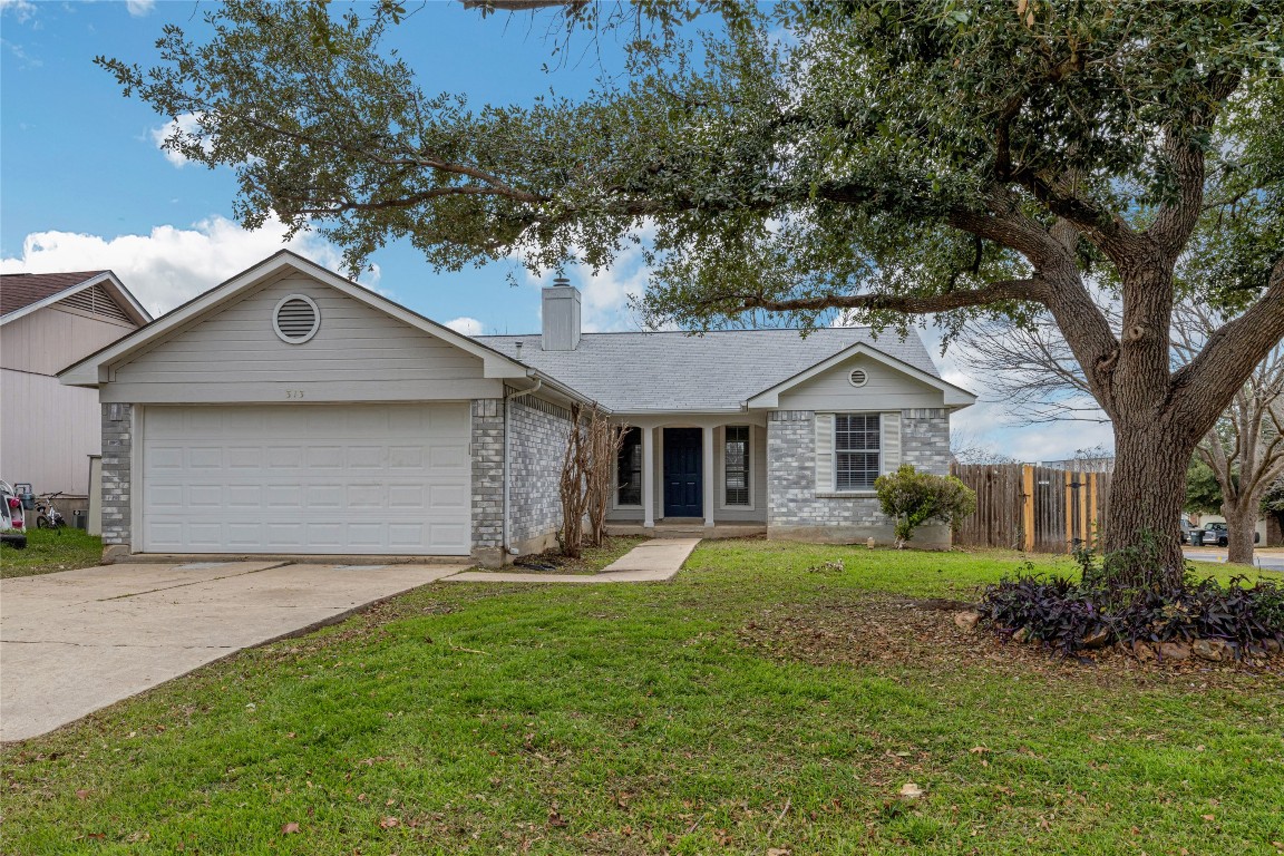 313 Caladium Drive Georgetown, TX 78626 - Photo 2 of 36 a front view of a house with a yard and garage