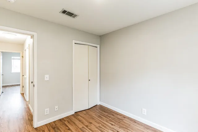 a view of a room with wooden floor