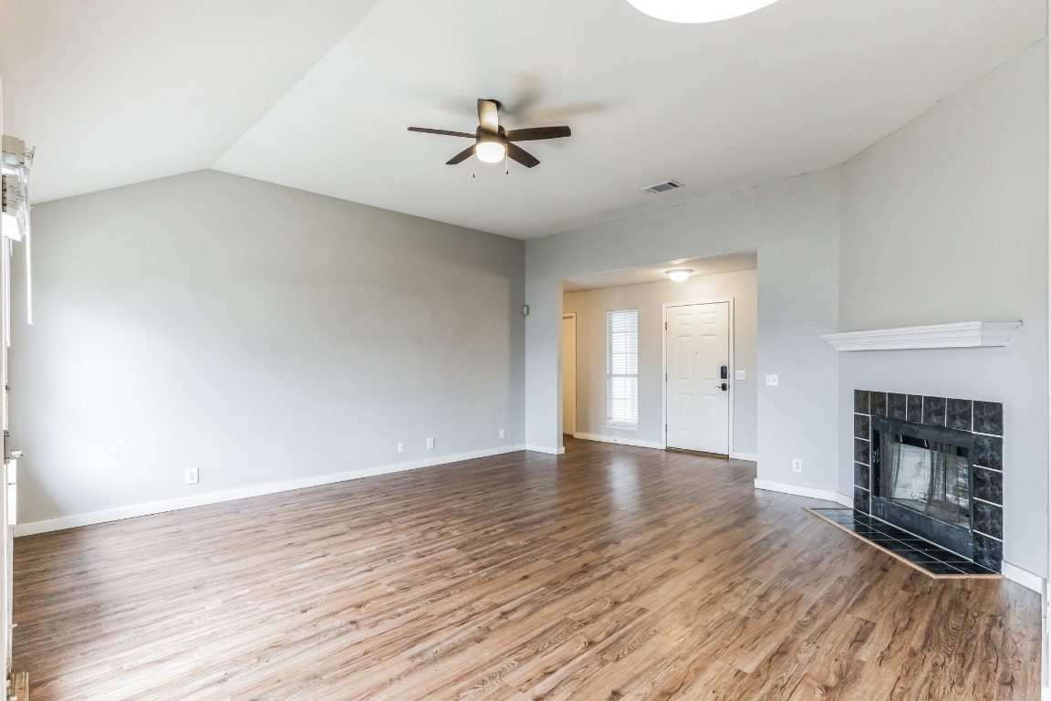 313 Caladium Drive Georgetown, TX 78626 - Photo 7 of 36 a view of an empty room with wooden floor fireplace and a window