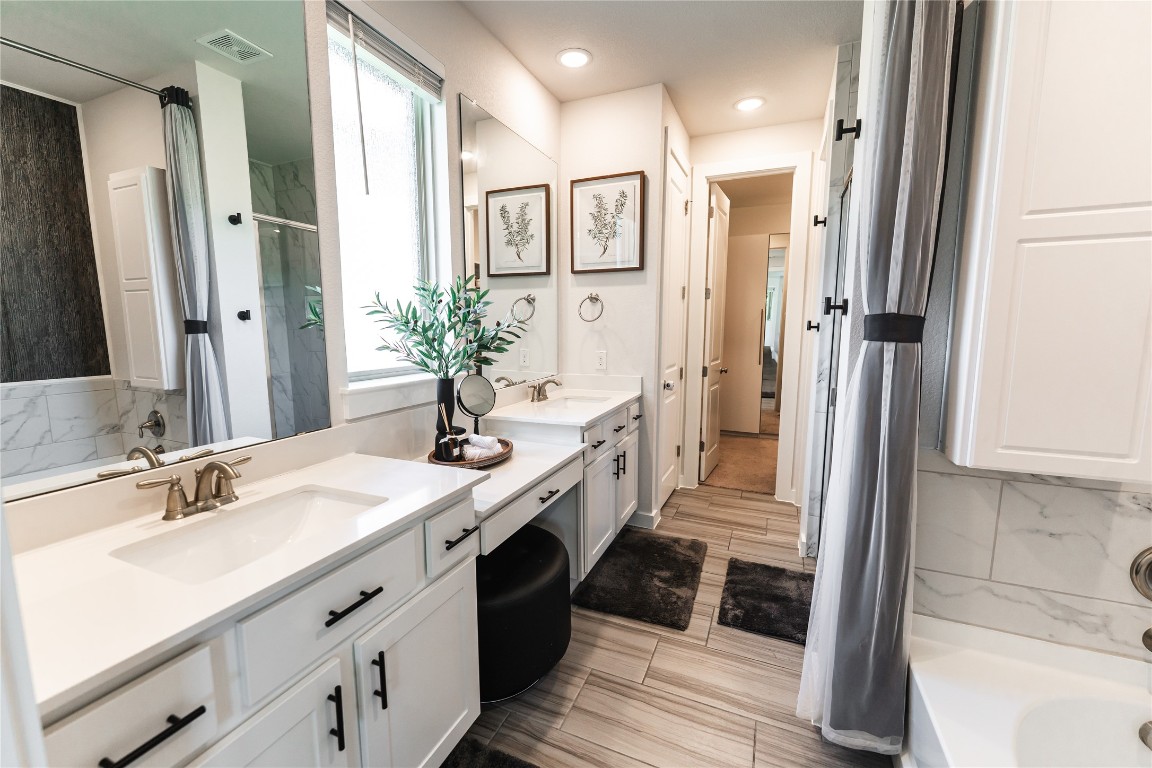 608 Pecan Bottom Trail Georgetown, TX 78628 - Photo 13 of 30 Bathroom with double vanity, tasteful backsplash, and a combined bath / shower with marble appearance
